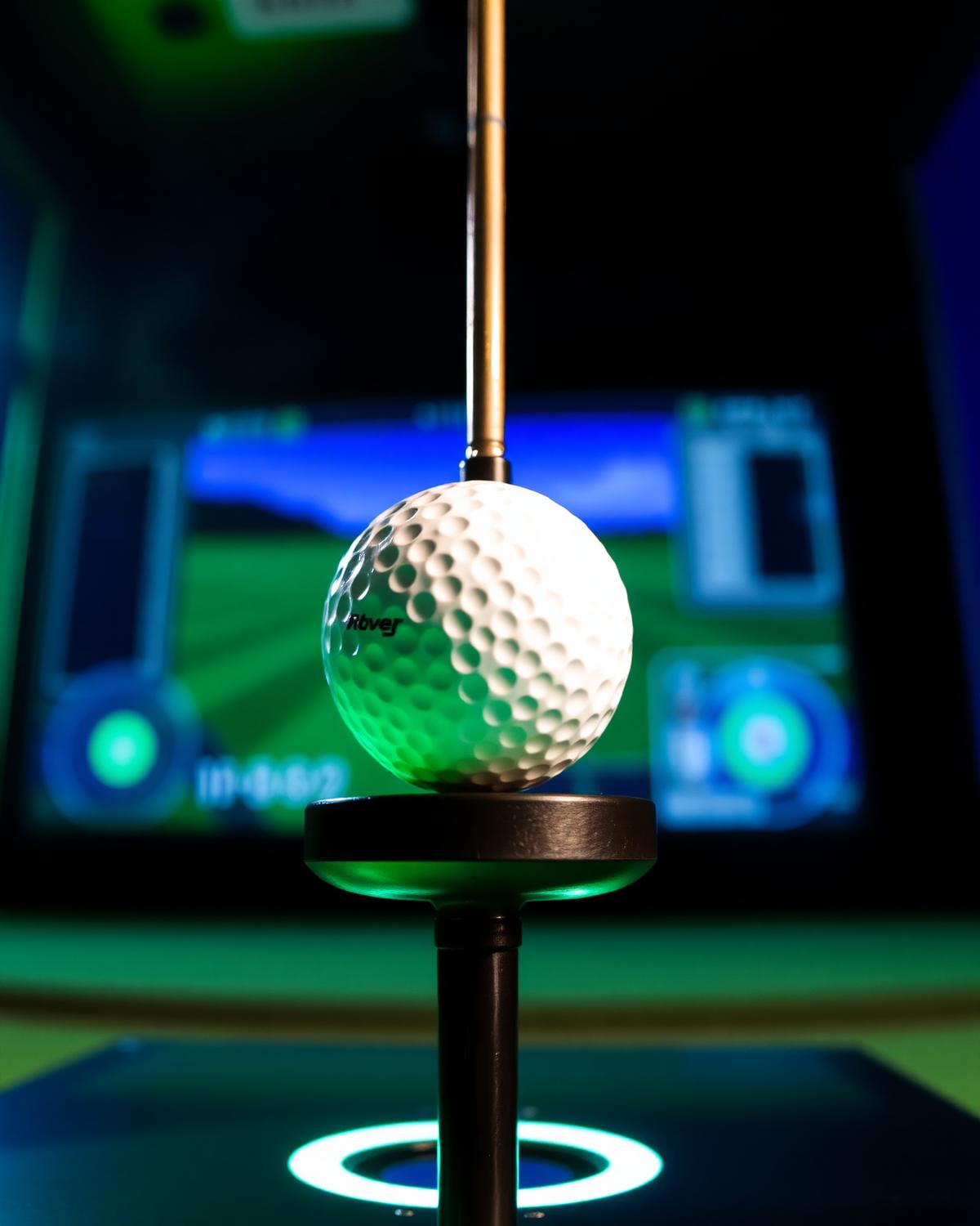 Golf ball on a professional launch monitor with simulator screen